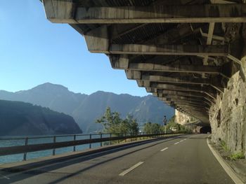 Road leading towards mountain against sky