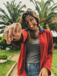 Midsection of woman holding plant