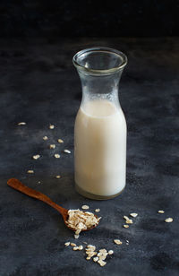 High angle view of oat flake with milk against black background