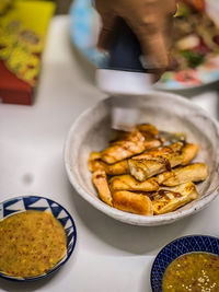 Cropped hand of man preparing food