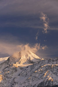 Aerial view of snowcapped mountains against sky