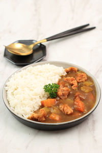 Japanese or korean curry with rice - japanese food style. served on ceramic plate isolated 