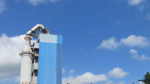 Low angle view of cement factory against sky