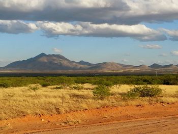 Scenic view of mountains against cloudy sky