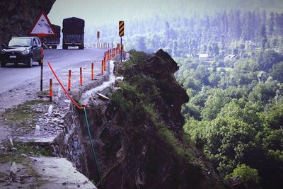 Vehicles on mountain road by landscape