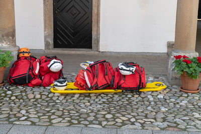 View of backpacks on street against house