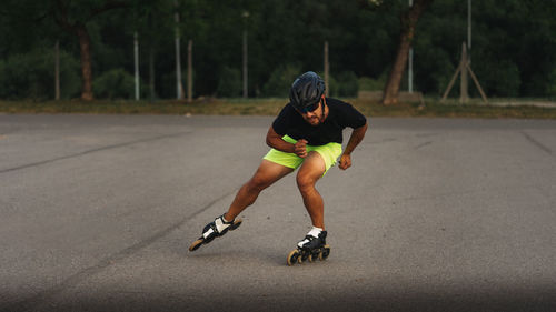 Full length of man inline skating on road