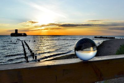 Reflection in sea against sky during sunset