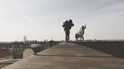 Full length of woman standing on railing