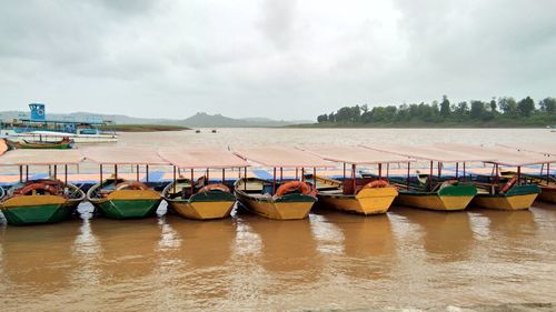 Boats moored on sea against sky