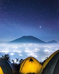 Scenic view of mountains against sky at night