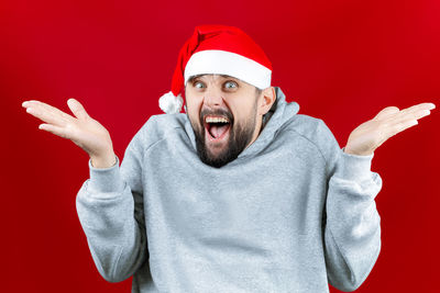 Midsection of man wearing hat against red background