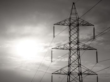 Low angle view of electricity pylon against sky