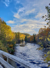 Scenic view of river against sky during autumn