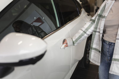 Woman next to white car