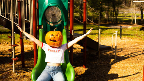 Rear view of boy standing in park