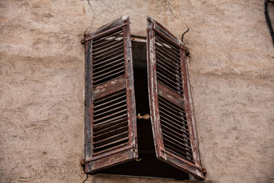 Low angle view of window on old building