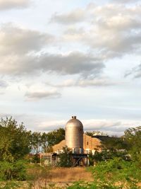 Old building in field against sky