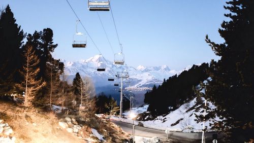 Ski lift against sky during winter