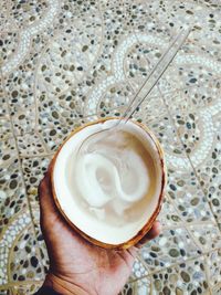 Close-up of hand holding coffee cup