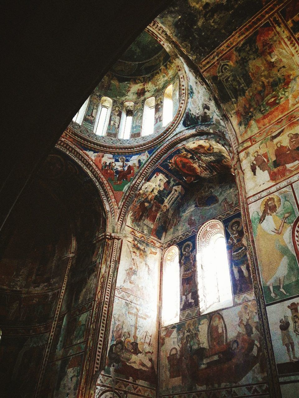 low angle view, architecture, religion, indoors, place of worship, spirituality, window, belief, built structure, no people, building, arch, day, ceiling, history, glass, ornate, altar, mural