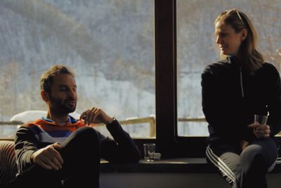 Young couple looking through window