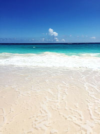 Scenic view of beach against blue sky