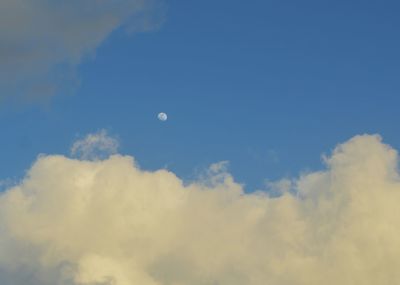 Low angle view of moon against blue sky