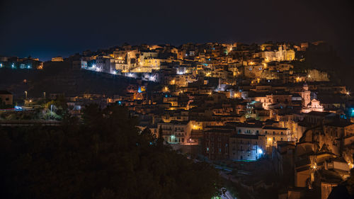 High angle view of illuminated buildings in city at night