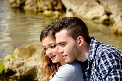 Young couple sitting at beach