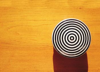 Close-up of yellow cup over white background