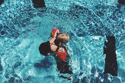 High angle view of girl swimming in pool