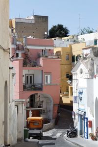 Cars on road by buildings in town