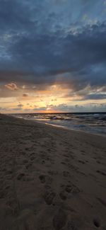 Scenic view of beach against sky during sunset