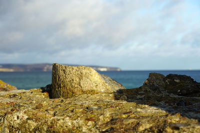 Rocks on beach against sky