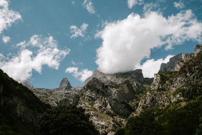 Low angle view of rocky mountains against sky