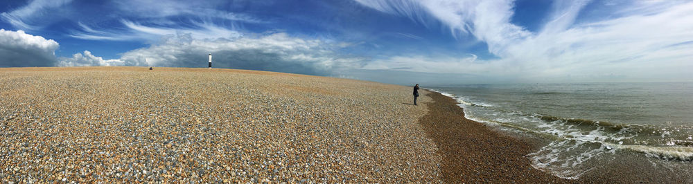 Man standing on beach against sky