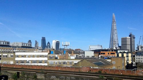 View of cityscape against blue sky