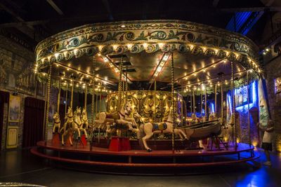 Illuminated carousel in amusement park