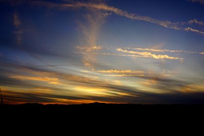 Low angle view of silhouette land against sky during sunset