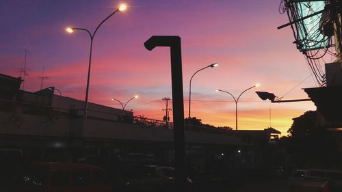 Silhouette of city street against dramatic sky