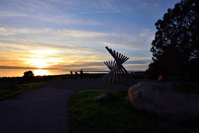 Scenic view of silhouette rocks against sky during sunset