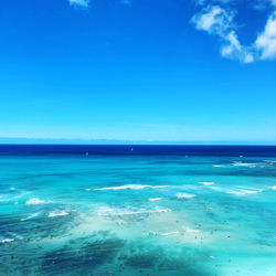 Scenic view of sea against blue sky