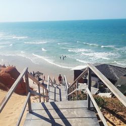 High angle view of deck chairs on beach against sky