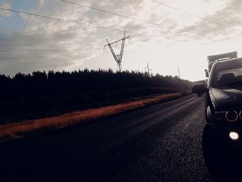 Cars on road against sky