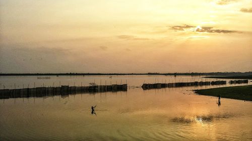 Scenic view of lake against sky during sunset