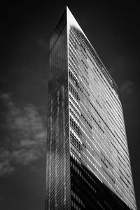 Low angle view of modern building against sky at night