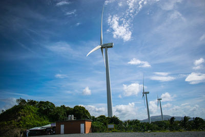 Low angle view of windmill against sky