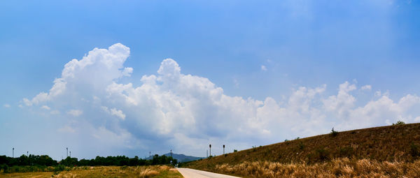 Panoramic view of road amidst land against sky