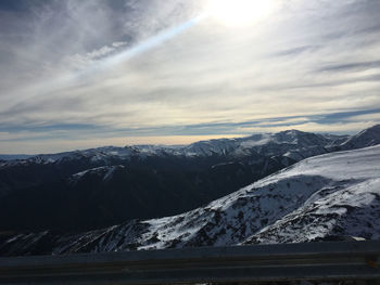 High angle view of snowcapped mountains against cloudy sky